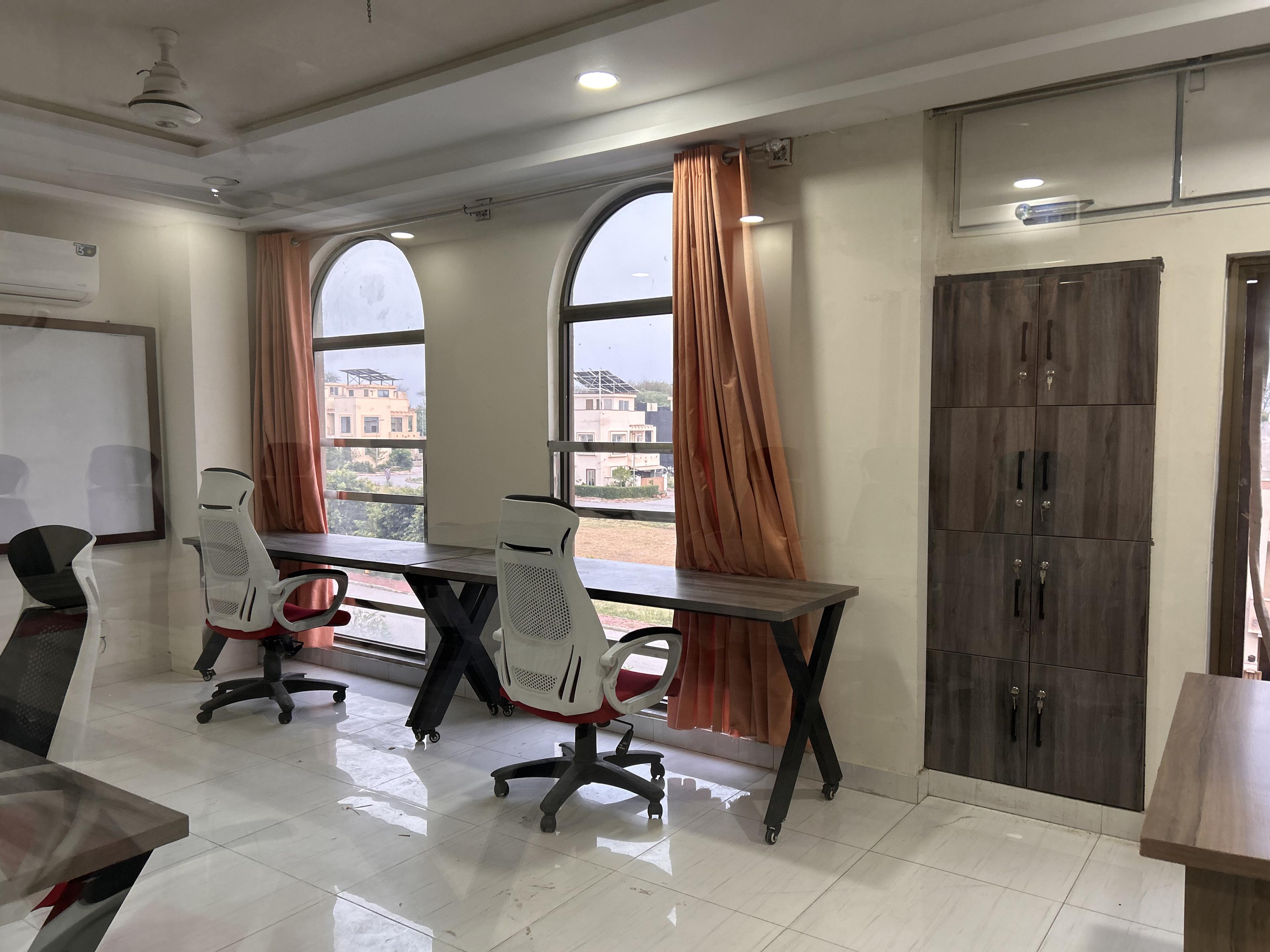 Bright furnished office environment with desks and chairs