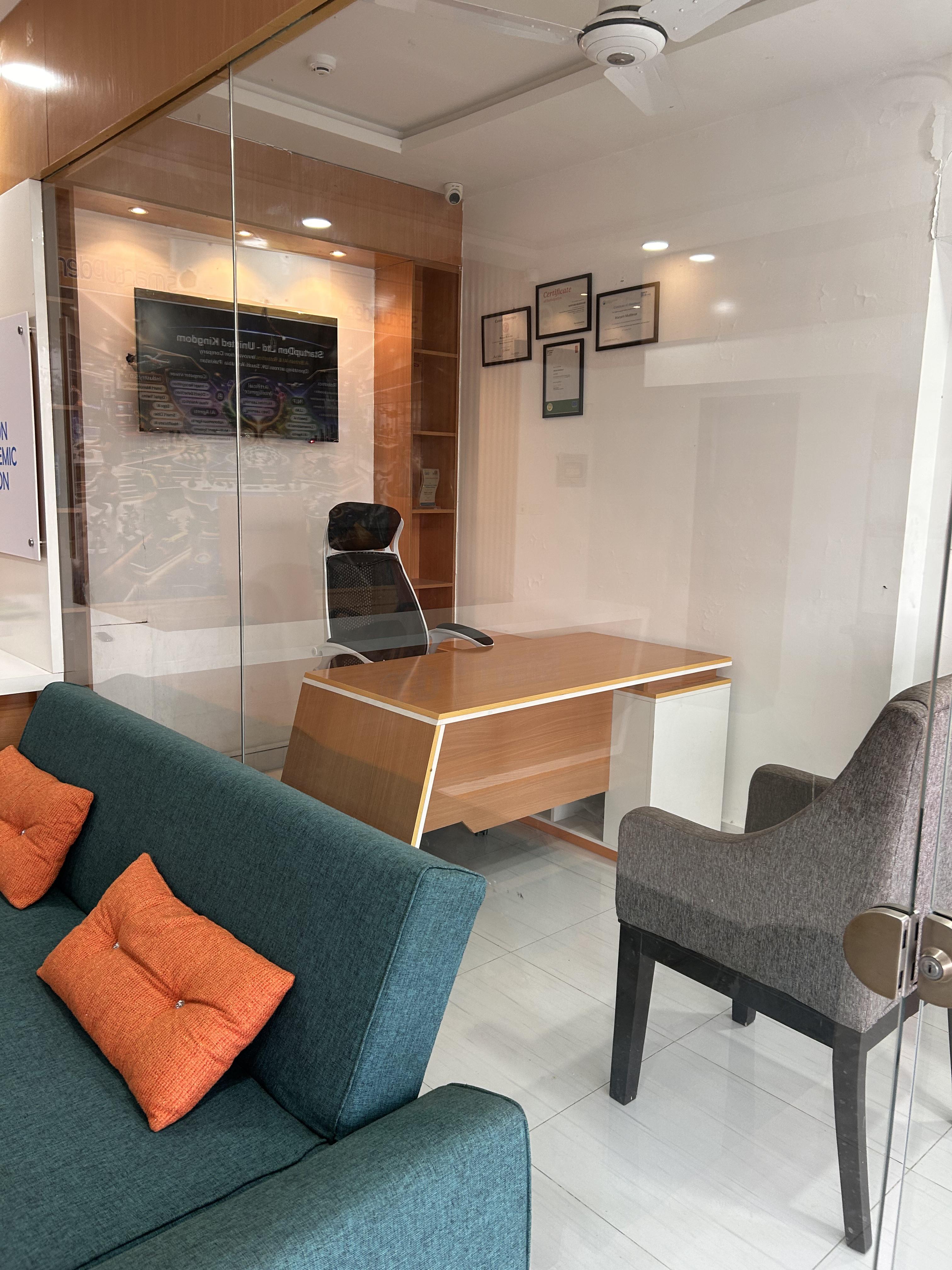Furnished office visible from the reception area